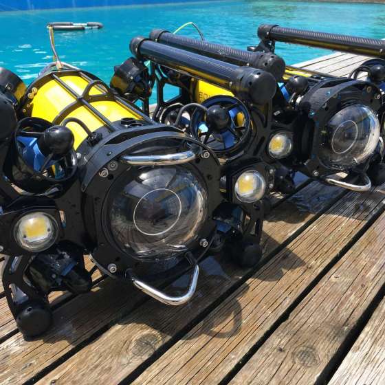 A pair of Boxfish ROVs beside the pool
